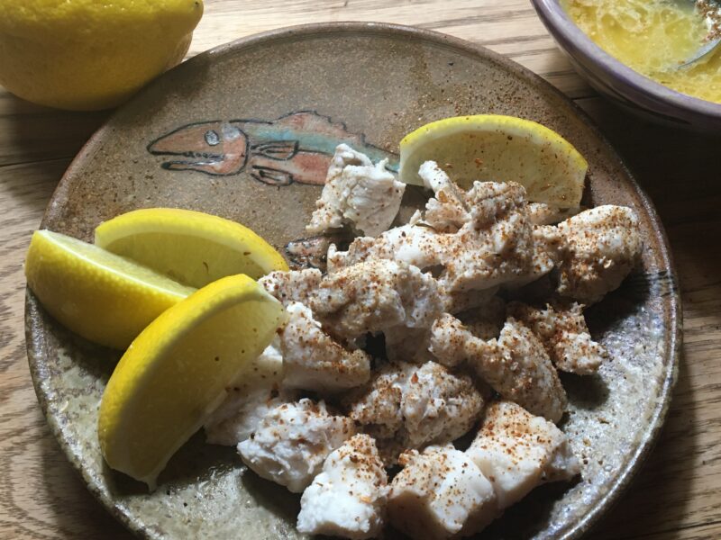 Lobster sprinkled in red spices, butter, and lemons