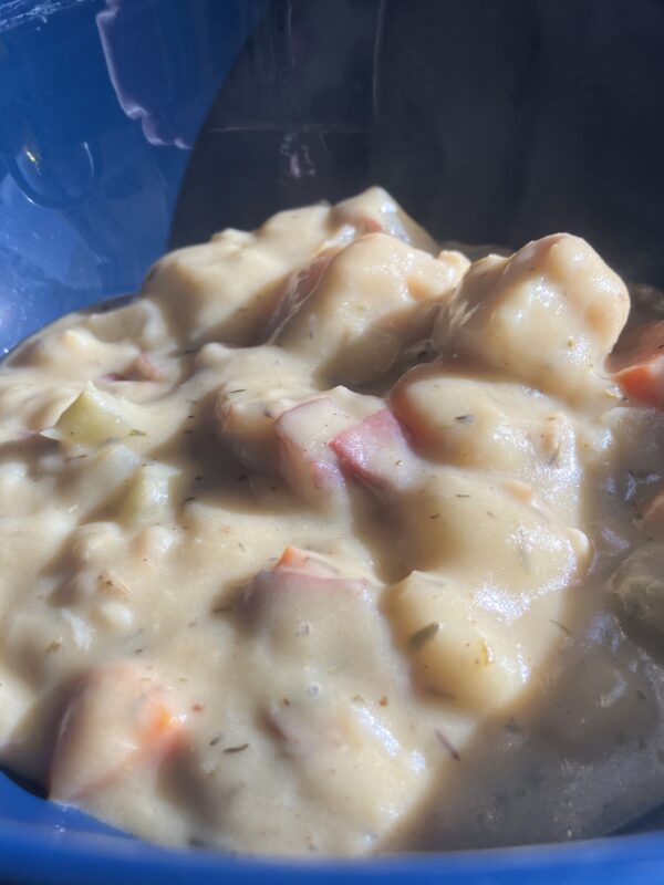 Creamy fish chowder in a blue bowl.